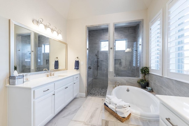 full bathroom with marble finish floor, plenty of natural light, a shower stall, and vanity