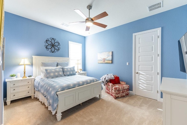 bedroom with light carpet, ceiling fan, and visible vents