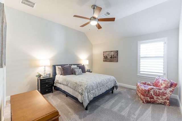 bedroom with light colored carpet, lofted ceiling, visible vents, and baseboards