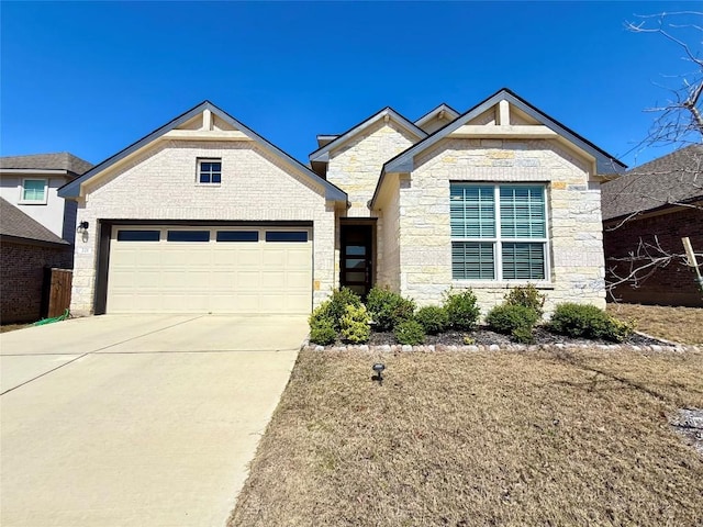 view of front of home featuring stone siding, concrete driveway, and an attached garage