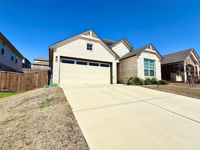 view of front facade with a garage, brick siding, fence, stone siding, and concrete driveway