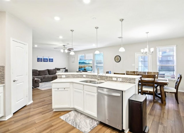 125 Danablu Dr, Hutto, TX 78634 - kitchen with stainless steel dishwasher, a sink, open floor plan, light wood-style flooring, and ceiling fan