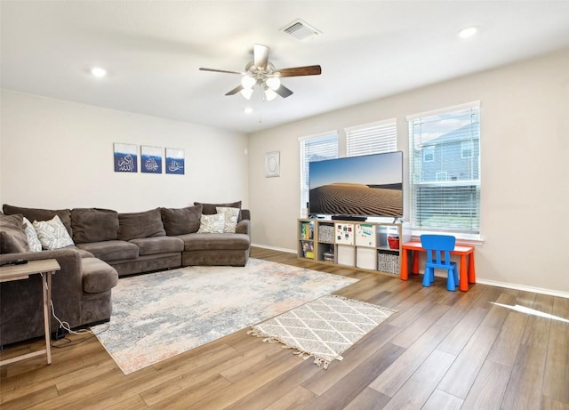 living room featuring recessed lighting, visible vents, a ceiling fan, wood finished floors, and baseboards