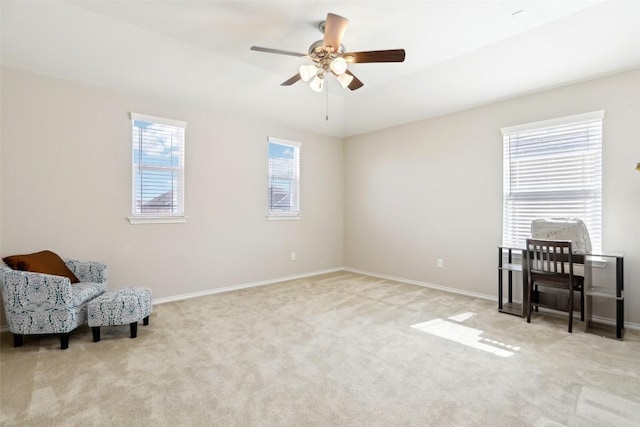 living area featuring carpet flooring, a ceiling fan, and baseboards