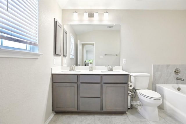 full bathroom with toilet, a garden tub, double vanity, and a sink