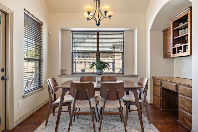 2618 Plantation Dr, Round Rock, TX 78681 - dining room featuring wood finished floors, a chandelier, baseboards, and arched walkways