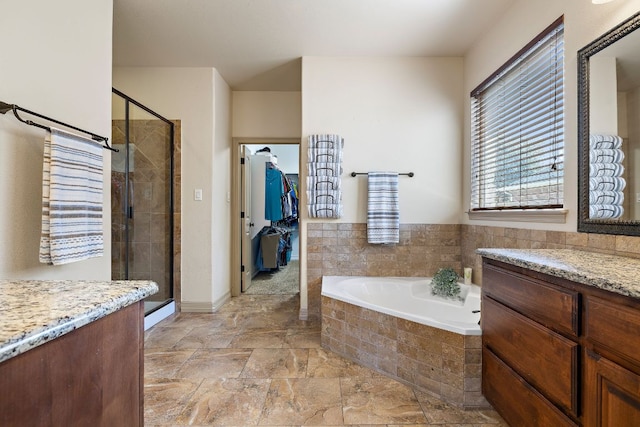 bathroom with a stall shower and a bath