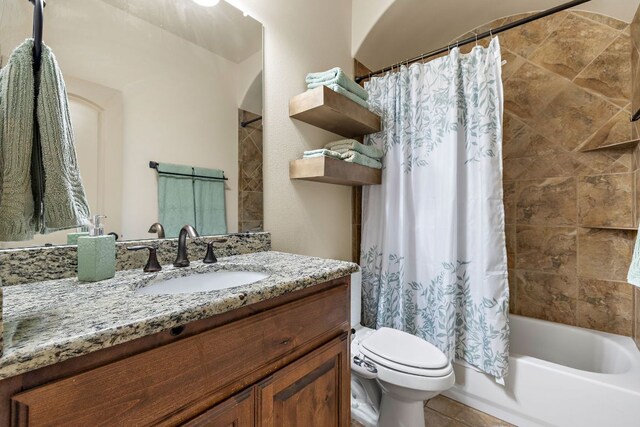 full bath featuring shower / bath combination with curtain, tile patterned flooring, vanity, and toilet