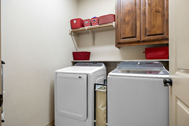 laundry room featuring cabinet space and separate washer and dryer