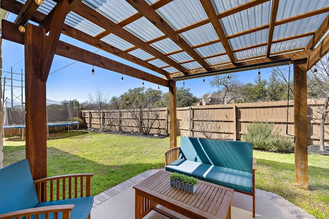 view of patio / terrace featuring an outdoor hangout area, a trampoline, and a fenced backyard