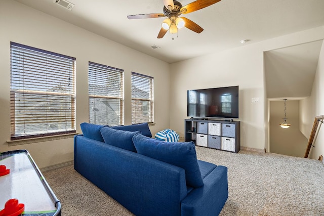 carpeted living area with ceiling fan and visible vents