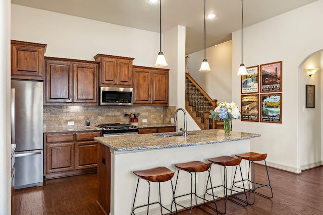 2618 Plantation Dr, Round Rock, TX 78681 - kitchen with appliances with stainless steel finishes, a sink, dark wood finished floors, and tasteful backsplash
