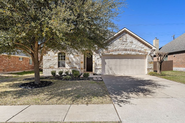 view of front facade with an attached garage, stone siding, and concrete driveway