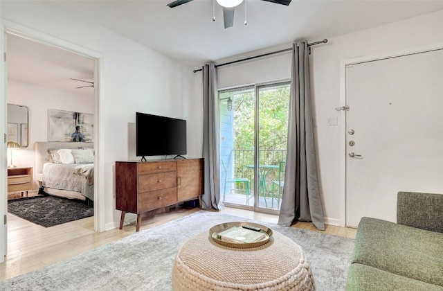 living area featuring wood finished floors and a ceiling fan