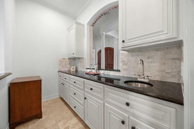 bathroom featuring vanity, tile patterned floors, decorative columns, tasteful backsplash, and ornamental molding