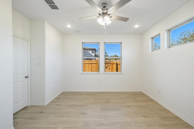 empty room featuring light wood-style flooring, baseboards, a ceiling fan, and recessed lighting