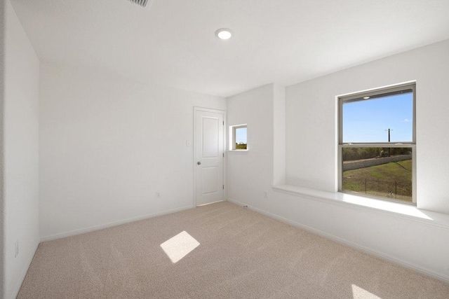 empty room with carpet floors and baseboards