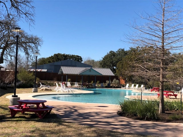 community pool featuring a patio area and fence