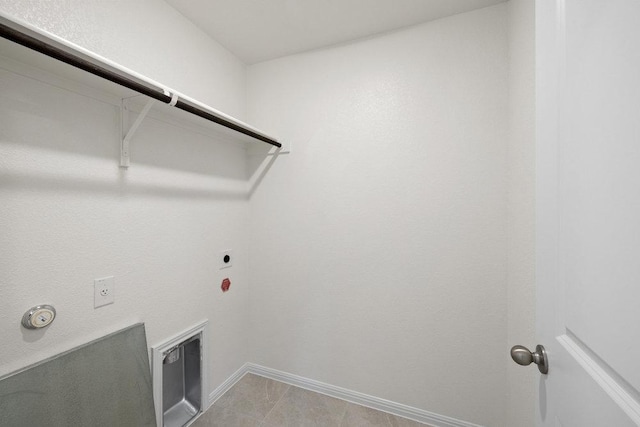 clothes washing area featuring laundry area, gas dryer hookup, electric dryer hookup, and baseboards