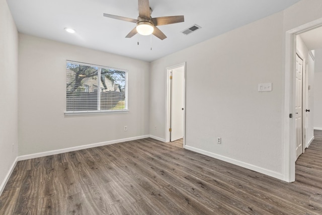 unfurnished bedroom with a ceiling fan, wood finished floors, visible vents, and baseboards