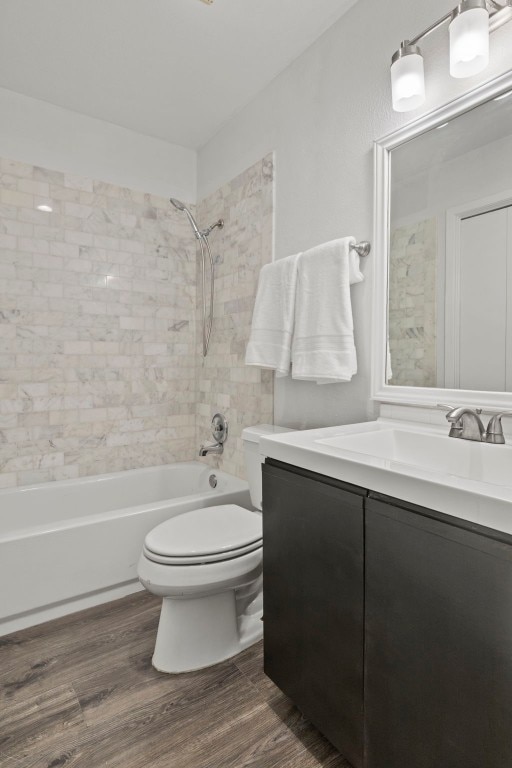 full bath featuring shower / bathtub combination, vanity, wood finished floors, and toilet