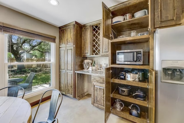 kitchen featuring appliances with stainless steel finishes, open shelves, concrete flooring, and recessed lighting