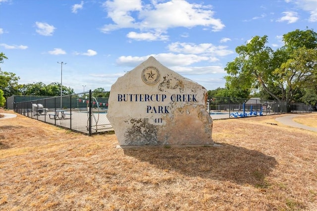 community / neighborhood sign with fence