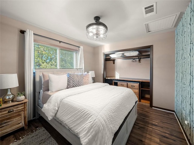 bedroom with baseboards, attic access, visible vents, and dark wood-style flooring