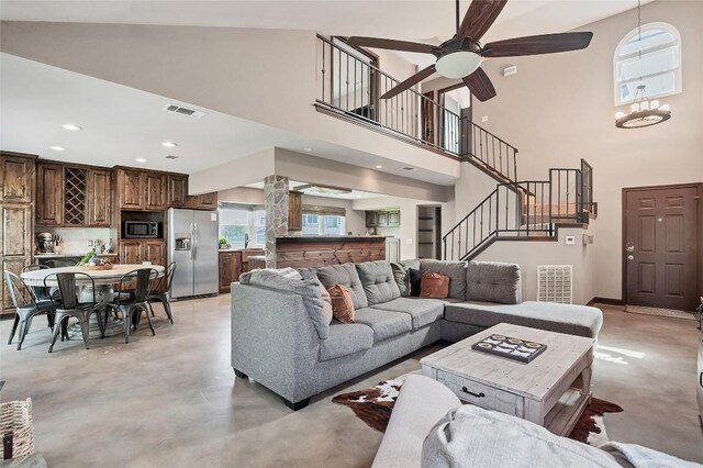 living room with baseboards, concrete floors, stairway, and recessed lighting