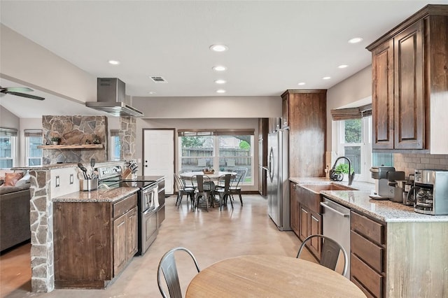 kitchen featuring stainless steel appliances, visible vents, decorative backsplash, light stone countertops, and extractor fan