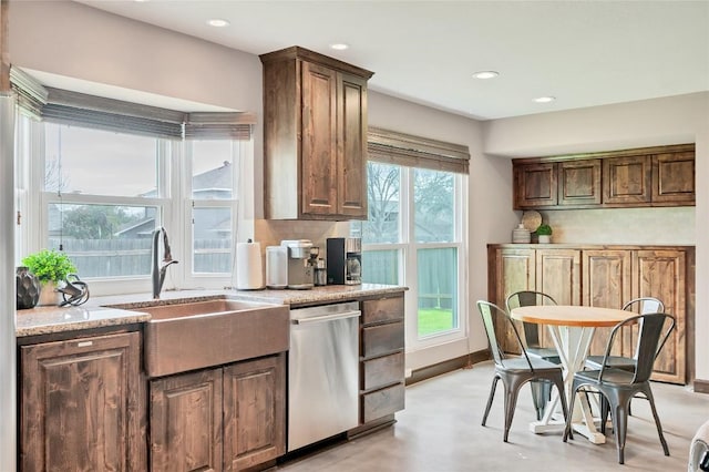 kitchen with recessed lighting, backsplash, stainless steel dishwasher, a sink, and baseboards