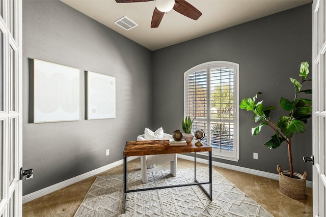 carpeted home office featuring visible vents, ceiling fan, and baseboards