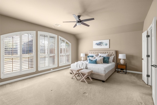 bedroom featuring a ceiling fan, baseboards, vaulted ceiling, and carpet flooring