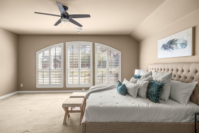 carpeted bedroom with visible vents, vaulted ceiling, baseboards, and ceiling fan