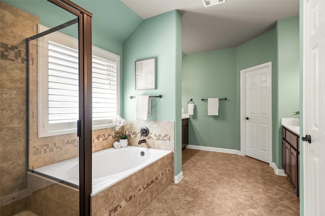 full bath featuring plenty of natural light, a garden tub, and vanity