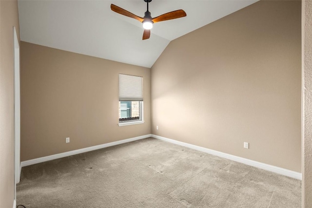 spare room with carpet, ceiling fan, lofted ceiling, and baseboards