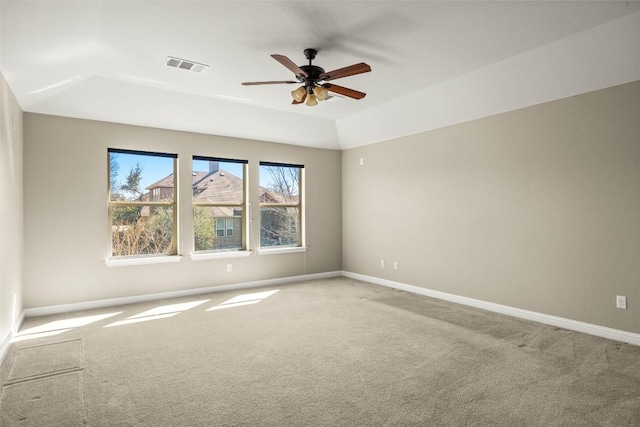 empty room with baseboards, visible vents, ceiling fan, and carpet flooring