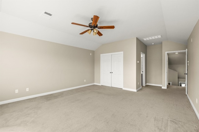 unfurnished bedroom featuring a closet, visible vents, vaulted ceiling, and baseboards