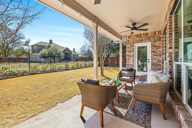 view of patio with outdoor lounge area, fence, and ceiling fan