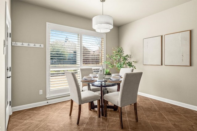 dining space featuring tile patterned floors and baseboards