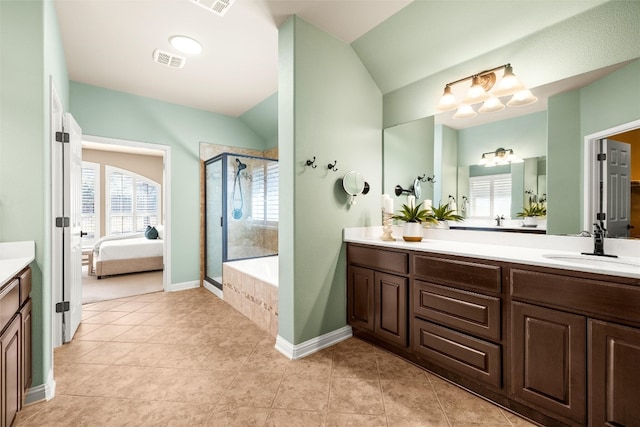 ensuite bathroom with visible vents, vanity, vaulted ceiling, a stall shower, and ensuite bath