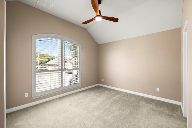 unfurnished room with light carpet, visible vents, baseboards, vaulted ceiling, and a ceiling fan