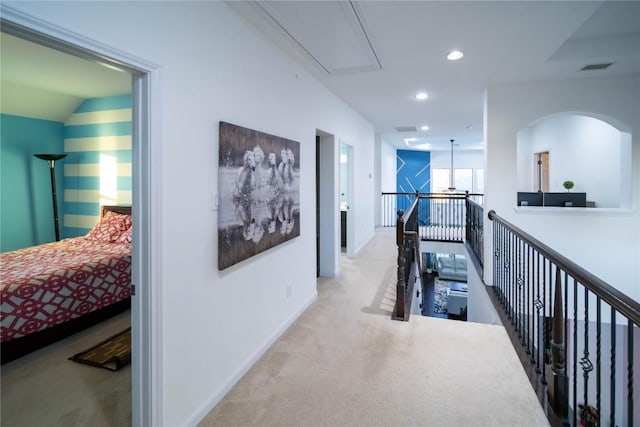 corridor featuring attic access, visible vents, an upstairs landing, carpet floors, and recessed lighting