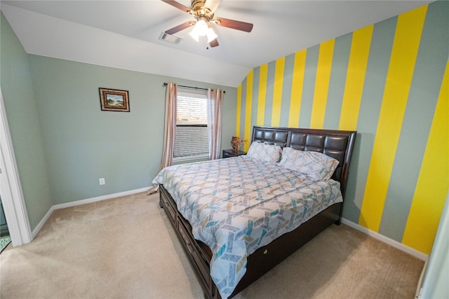 carpeted bedroom with lofted ceiling, a ceiling fan, visible vents, and baseboards