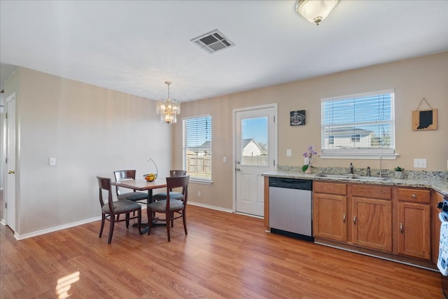 kitchen featuring light wood-style flooring, a sink, visible vents, brown cabinets, and dishwasher