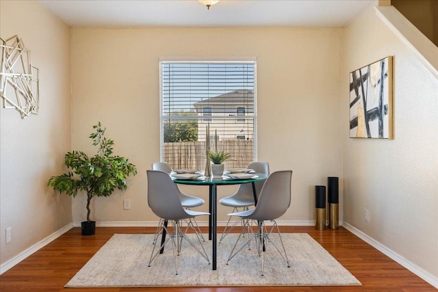 dining area featuring baseboards and wood finished floors