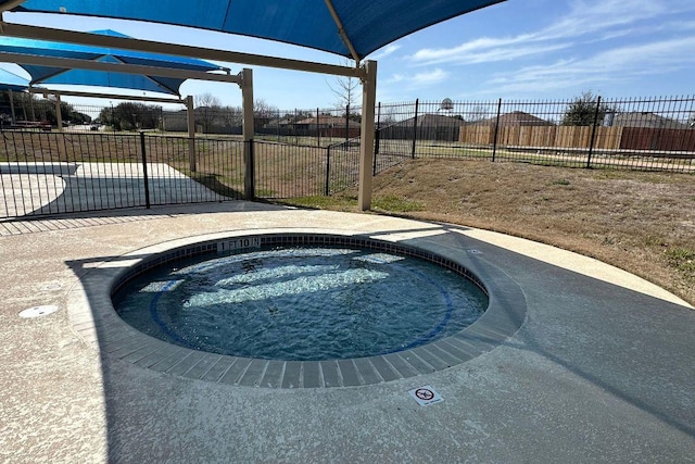 view of pool with fence and an in ground hot tub