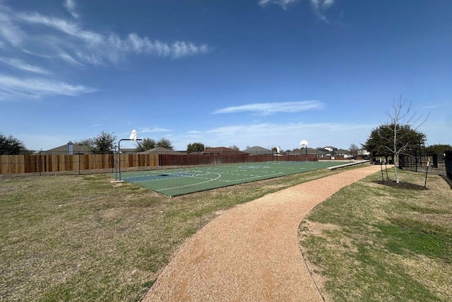 view of basketball court with community basketball court, a yard, and fence