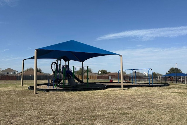 communal playground with fence and a lawn