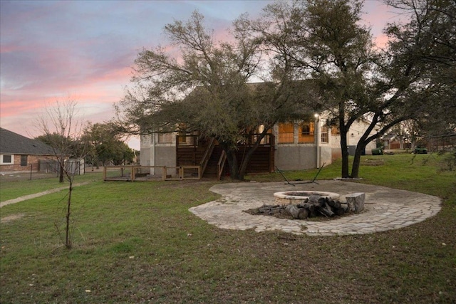 view of yard featuring an outdoor fire pit, fence, stairway, and a wooden deck